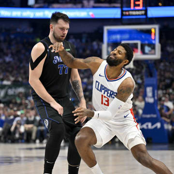 May 3, 2024; Dallas, Texas, USA; LA Clippers forward Paul George (13) is fouled by Dallas Mavericks guard Luka Doncic (77) during the first quarter during game six of the first round for the 2024 NBA playoffs at American Airlines Center. Mandatory Credit: Jerome Miron-USA TODAY Sports