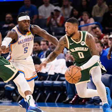 Oct 17, 2023; Oklahoma City, Oklahoma, USA; Milwaukee Bucks guard Damian Lillard (0) dribbles while defended by Oklahoma City Thunder guard Luguentz Dort (5) during the first half at Paycom Center. Mandatory Credit: Rob Ferguson-Imagn Images