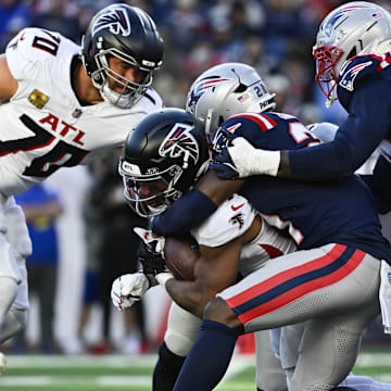 Nov 2, 2025; Foxborough, Massachusetts, USA;  Atlanta Falcons running back Bijan Robinson (7) is tackled by New England Patriots safety Jaylinn Hawkins (21) during the third quarter at Gillette Stadium. Mandatory Credit: Eric Canha-Imagn Images