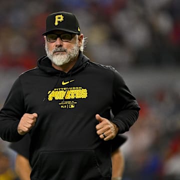 Aug 21, 2024; Arlington, Texas, USA; Pittsburgh Pirates manager Derek Shelton (17) runs back to the doughnut during the game against the Texas Rangers at Globe Life Field. Mandatory Credit: Jerome Miron-Imagn Images