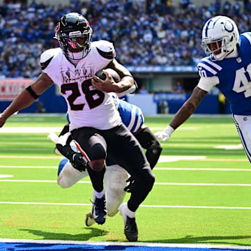 Sep 8, 2024; Indianapolis, Indiana, USA; Houston Texans running back Joe Mixon (28) runs the ball in for a touchdown in front of Indianapolis Colts cornerback Jaylon Jones (40) during the second half at Lucas Oil Stadium. Mandatory Credit: Marc Lebryk-Imagn Images