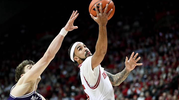 Feb 24, 2026; Bloomington, Indiana, USA; Indiana Hoosiers guard Tayton Conerway (6) scores past Northwestern Wildcats forward Nick Martinelli (2) during the first half at Simon Skjodt Assembly Hall. Mandatory Credit: Robert Goddin-Imagn Images