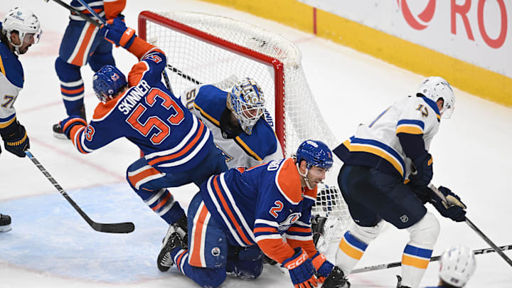 Apr 9, 2025; Edmonton, Alberta, CAN; Edmonton Oilers center Jeff Skinner (53) crashes into St. Louis Blues goalie Jordan Binnington (50) as Oilers defenseman Evan Bouchard (2) hits the ice during the third period at Rogers Place. Mandatory Credit: Walter Tychnowicz-Imagn Images