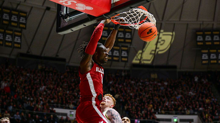 Nov 15, 2024; West Lafayette, Indiana, USA; Alabama Crimson Tide center Clifford Omoruyi (11) dunks over Purdue Boilermakers center Will Berg (44) during the first half at Mackey Arena. Mandatory Credit: Marc Lebryk-Imagn Images