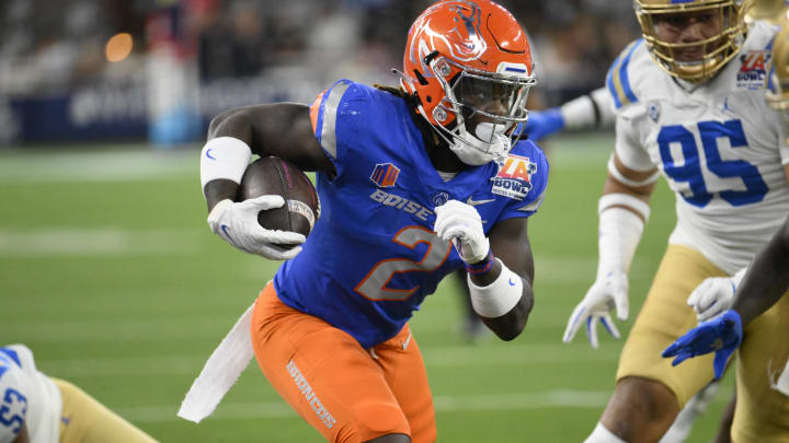 Dec 16, 2023; Inglewood, CA, USA; Boise State Broncos running back Ashton Jeanty (2) slips a tackle by UCLA Bruins linebacker Darius Muasau (53) during the first quarter of the Starco Brands LA Bowl at SoFi Stadium. Mandatory Credit: Robert Hanashiro-USA TODAY Sports