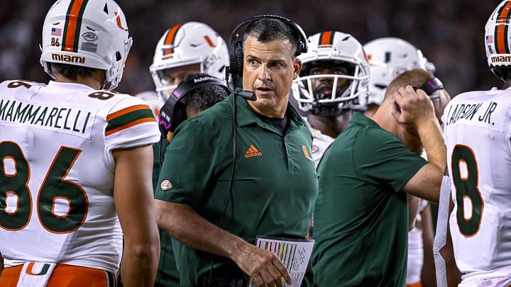 Sep 17, 2022; College Station, Texas, USA; Miami Hurricanes head coach Mario Cristobal talks with this team during a timeout during the second half of the game between the Texas A&M Aggies and the Miami Hurricanes at Kyle Field. Mandatory Credit: Jerome Miron-Imagn Images