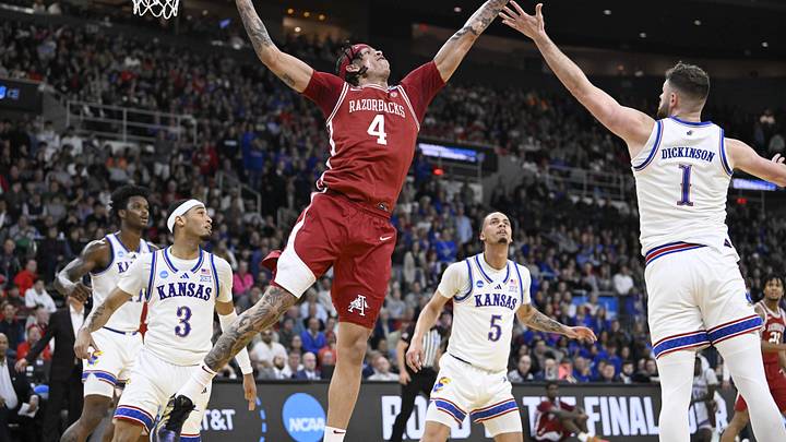Mar 20, 2025; Providence, RI, USA;  Arkansas Razorbacks forward Trevon Brazile (4) reaches for the ball against Kansas Jayhawks center Hunter Dickinson (1) during the second half at Amica Mutual Pavilion. Mandatory Credit: Eric Canha-Imagn Images
