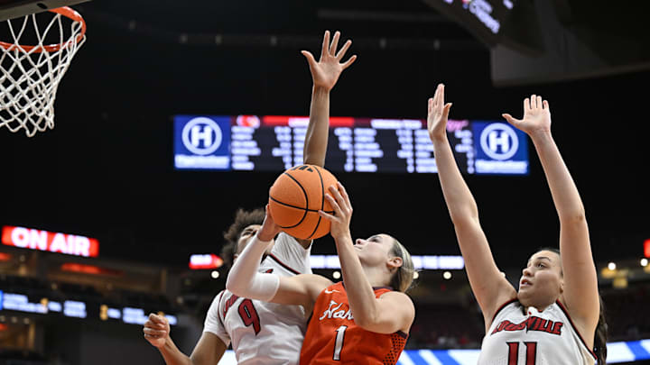 Jan 4, 2026; Louisville, Kentucky, USA;  Virginia Tech Hokies guard Carleigh Wenzel (1) shoots against Louisville Cardinals forward Anaya Hardy (9) and forward Elif Istanbulluoglu (11) during the second half at KFC Yum! Center. Louisville defeated Virginia Tech 85-60. Mandatory Credit: Jamie Rhodes-Imagn Images