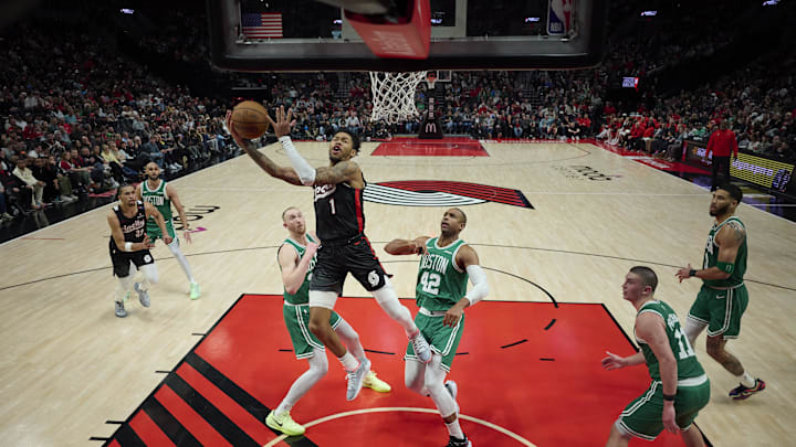 Mar 23, 2025; Portland, Oregon, USA; Portland Trail Blazers guard Anfernee Simons (1) scores a basket during the second half against Boston Celtics center Al Horford (42) and forward Sam Hauser (30) at Moda Center. Mandatory Credit: Troy Wayrynen-Imagn Images