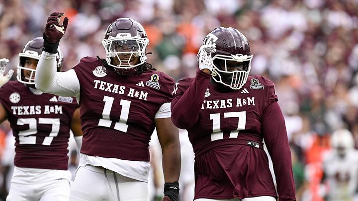 Dec 20, 2025; College Station, TX, USA; Texas A&M Aggies defensive tackle Albert Regis (17) and defensive tackle Tyler Onyedim (11) celebrate during the game between the Aggies and the Hurricanes at Kyle Field. Mandatory Credit: Jerome Miron-Imagn Images