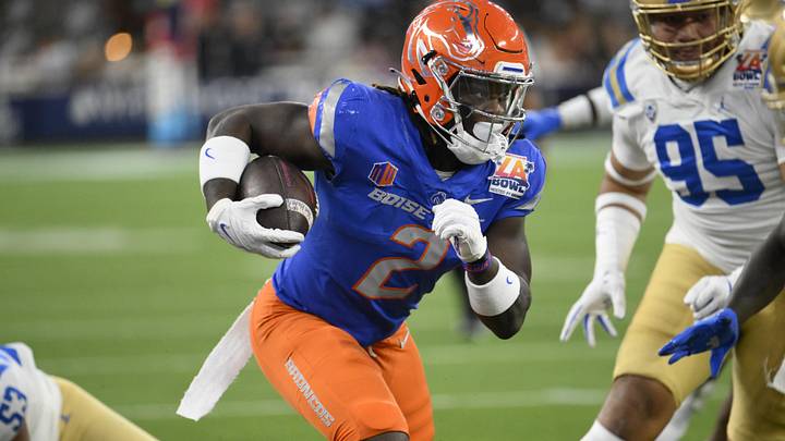 Dec 16, 2023; Inglewood, CA, USA; Boise State Broncos running back Ashton Jeanty (2) slips a tackle by UCLA Bruins linebacker Darius Muasau (53) during the first quarter of the Starco Brands LA Bowl at SoFi Stadium. 
