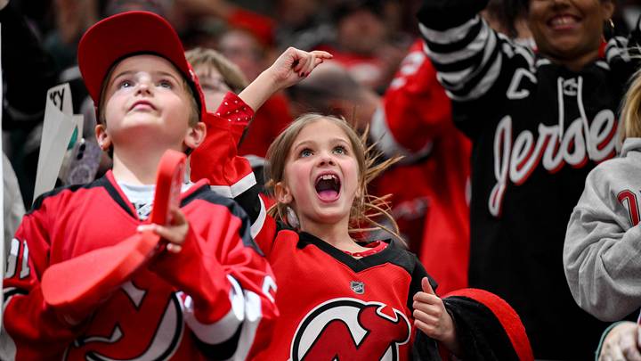 Devils fans celebrating a Dawson Mercer goal in April 2026