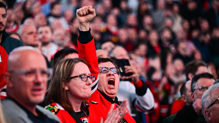 Feb 5, 2025; Chicago, Illinois, USA; A Chicago Blackhawks fan cheers during the national anthem before the game against the Edmonton Oilers at the United Center. Mandatory Credit: Daniel Bartel-Imagn Images