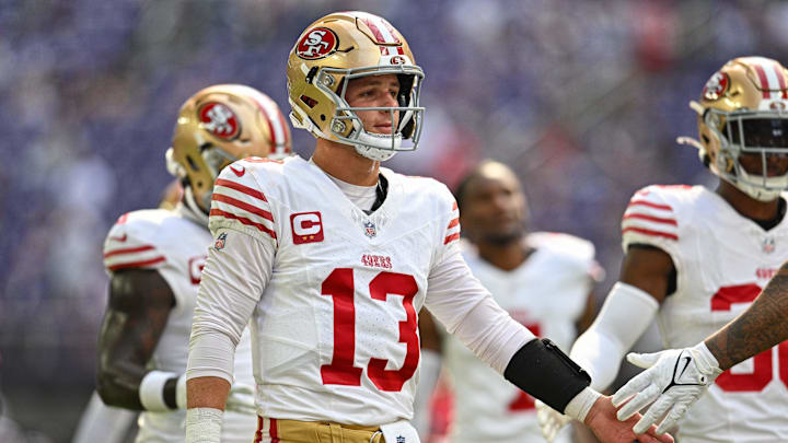 Sep 15, 2024; Minneapolis, Minnesota, USA; San Francisco 49ers quarterback Brock Purdy (13) warms up with teammates before the game against the Minnesota Vikings at U.S. Bank Stadium. Mandatory Credit: Jeffrey Becker-Imagn Images