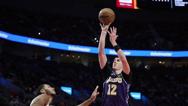 Nov 3, 2025; Portland, Oregon, USA; Los Angeles Lakers forward Jake LaRavia (12) shoots a basket during the second half against Portland Trail Blazers forward Kris Murray (24) at Moda Center. Mandatory Credit: Troy Wayrynen-Imagn Images Nov 3, 2025; Portland, Oregon, USA; Los Angeles Lakers forward Jake LaRavia (12) shoots a basket during the second half against Portland Trail Blazers forward Kris Murray (24) at Moda Center. Mandatory Credit: Troy Wayrynen-Imagn Images