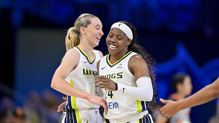 Jul 28, 2025; Arlington, Texas, USA; Dallas Wings guard Paige Bueckers (5) and guard Arike Ogunbowale (24) celebrate during the game between the Dallas Wings and the New York Liberty at College Park Center. Mandatory Credit: Jerome Miron-Imagn Images