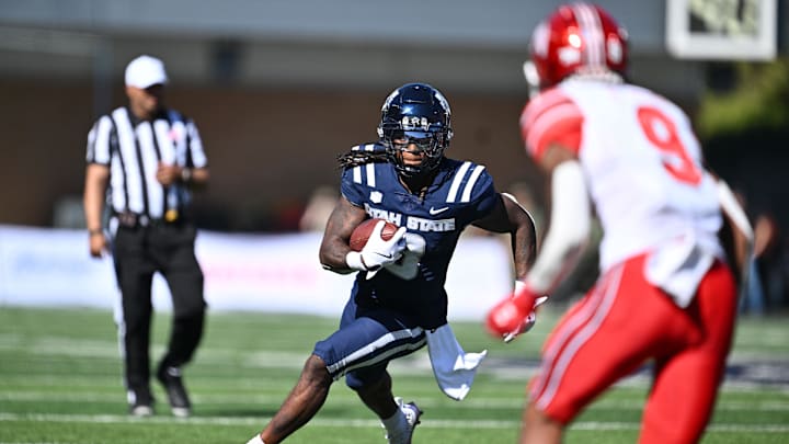 Sep 14, 2024; Logan, Utah, USA; Utah State Aggies running back Rahsul Faison (3) looks for running room in the first half against the Utah Utes at Merlin Olsen Field at Maverik Stadium. Mandatory Credit: Jamie Sabau-Imagn Images Sep 14, 2024; Logan, Utah, USA; Utah State Aggies running back Rahsul Faison (3) looks for running room in the first half against the Utah Utes at Merlin Olsen Field at Maverik Stadium. Mandatory Credit: Jamie Sabau-Imagn Images