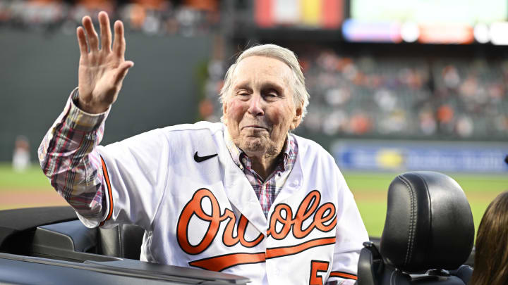  Hall of Fame member and former Baltimore Orioles player Brooks Robinson waves to the crowd prior to a game between the Orioles and the Houston Astros  at Oriole Park at Camden Yards on September 24, 2022.