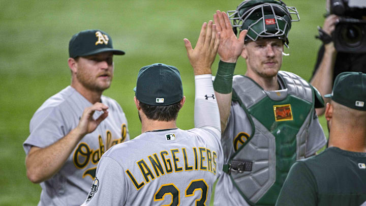 Aug 17, 2022; Arlington, Texas, USA; Oakland Athletics designated hitter Shea Langeliers (23) and catcher Sean Murphy (12) celebrate after the victory over the Texas Rangers at Globe Life Field. Mandatory Credit: Jerome Miron-Imagn Images
