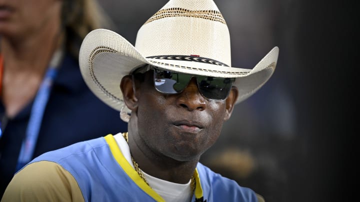 Jul 13, 2024; Arlington, TX, USA;  Colorado Buffalos head coach and former MLB and NFL player Deion Sanders (21) of the National League is interviewed during the 2024 All Star Celebrity Softball Game at Globe Life Field.