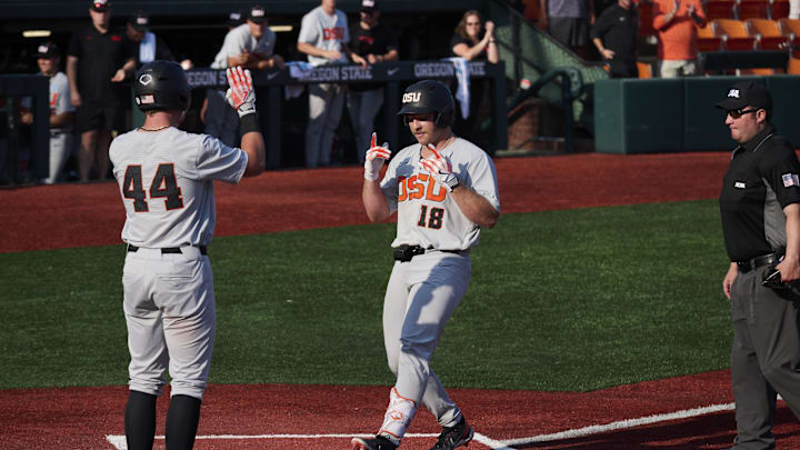 Jun 1, 2025; Corvallis, OR, USA; Oregon St. catcher Wilson Weber (18) celebrates hitting a home run during the ninth inning with infielder Trent Caraway (44) against Saint Mary's at the NCAA Corvallis Regional at Goss Stadium. Mandatory Credit: Troy Wayrynen-Imagn Images