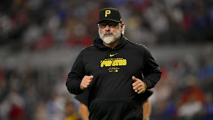 Aug 21, 2024; Arlington, Texas, USA; Pittsburgh Pirates manager Derek Shelton (17) runs back to the doughnut during the game against the Texas Rangers at Globe Life Field. Mandatory Credit: Jerome Miron-Imagn Images