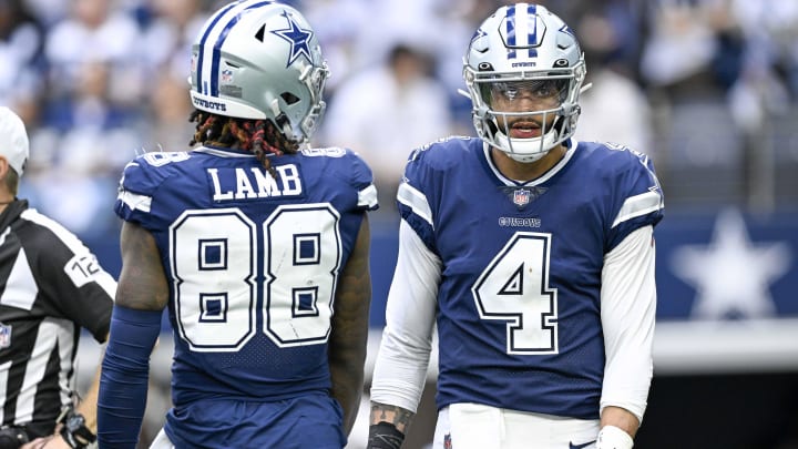 Cowboys quarterback Dak Prescott and wide receiver CeeDee Lamb chat during a game against the Chicago Bears at AT&T Stadium.