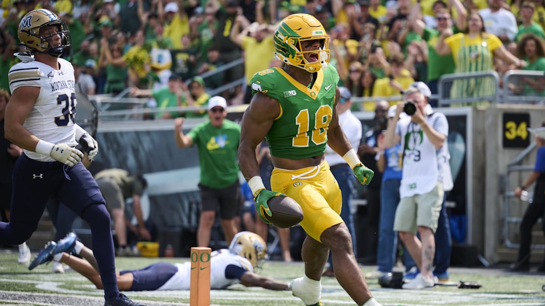 Aug 30, 2025; Eugene, Oregon, USA; Oregon Ducks tight end Kenyon Sadiq (18) scores a touchdown during the first half against the Montana State Bobcats at Autzen Stadium. Mandatory Credit: Troy Wayrynen-Imagn Images
