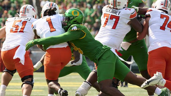 Sep 6, 2025; Eugene, Oregon, USA; Oregon Ducks linebacker Blake Purchase (9) tackles Oklahoma State Cowboys running back Kalib Hicks (1) during the second half at Autzen Stadium. Mandatory Credit: Troy Wayrynen-Imagn Images