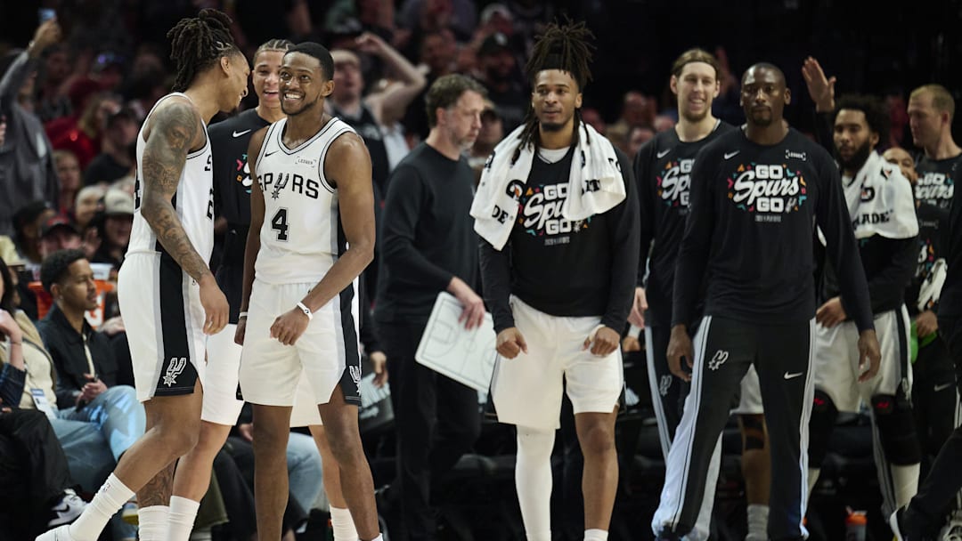 Apr 26, 2026; Portland, Oregon, USA; San Antonio Spurs guard Devin Vassell (24) and guard De'aaron Fox (4) celebrate during a break in the game during the second half against the Portland Trail Blazers during game four of the first round of the 2026 NBA Playoffs at Moda Center. Mandatory Credit: Troy Wayrynen-Imagn Images