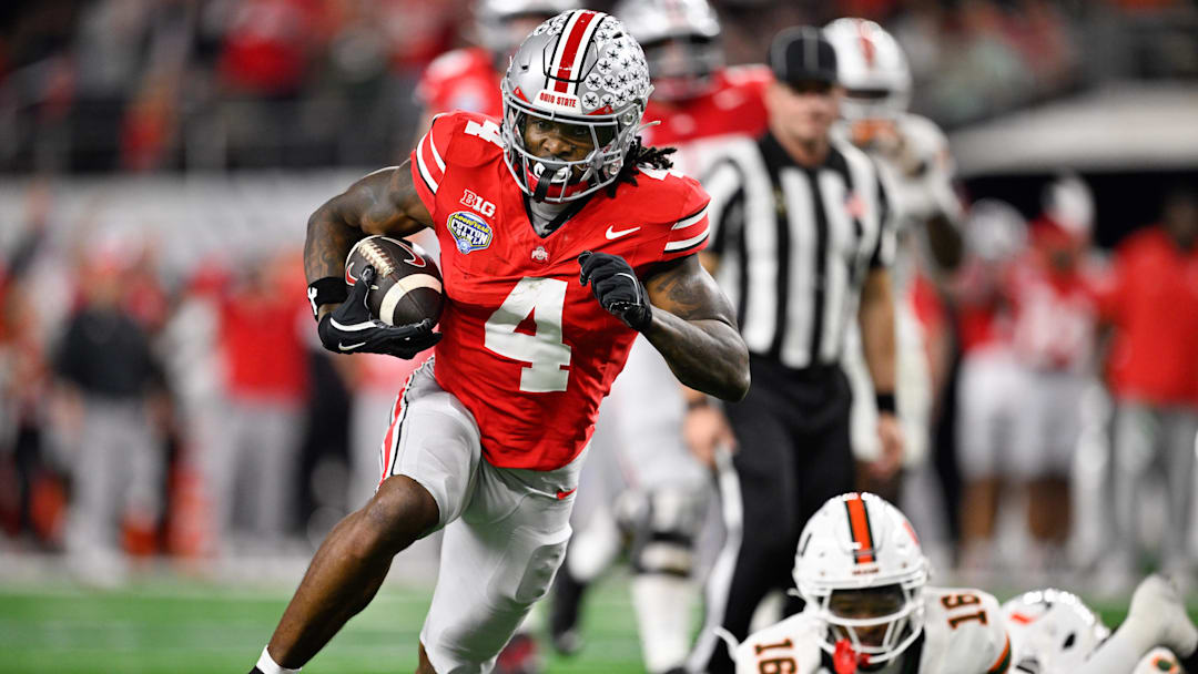 Dec 31, 2025; Arlington, TX, USA; Ohio State Buckeyes wide receiver Jeremiah Smith (4) runs the ball for a touchdown in the third quarter against the Miami Hurricanes during the 2025 Cotton Bowl and quarterfinal game of the College Football Playoff at AT&T Stadium. Mandatory Credit: Jerome Miron-Imagn Images