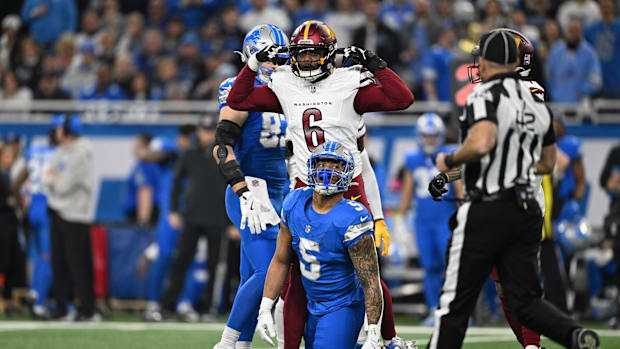 Washington Commanders linebacker Dante Fowler Jr. reacts to a tackle against Detroit Lions running back David Montgomery.