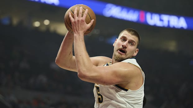 Oct 31, 2025; Portland, Oregon, USA; Denver Nuggets center Nikola Jokic (15) grabs a rebound during the first half against th