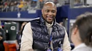 Jan 30, 2025; Arlington, TX, USA; Former NFL player Eddie George signs a football for the fans during the second half of the game between the East and the West at AT&T Stadium. Mandatory Credit: Jerome Miron-Imagn Images