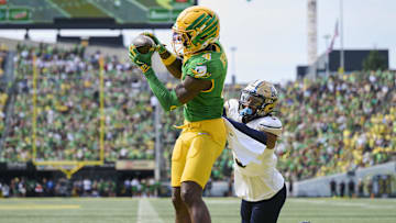 Aug 30, 2025; Eugene, Oregon, USA; Oregon Ducks wide receiver Malik Benson (4) catches a touchdown pass during the first half against Montana State Bobcats defensive back Seth Johnson (9) at Autzen Stadium. Mandatory Credit: Troy Wayrynen-Imagn Images