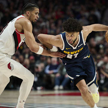 Mar 21, 2025; Portland, Oregon, USA; Denver Nuggets guard Jamal Murray (27) drives to the basket during the second half against Portland Trail Blazers forward Toumani Camara (33) at Moda Center. Mandatory Credit: Troy Wayrynen-Imagn Images
