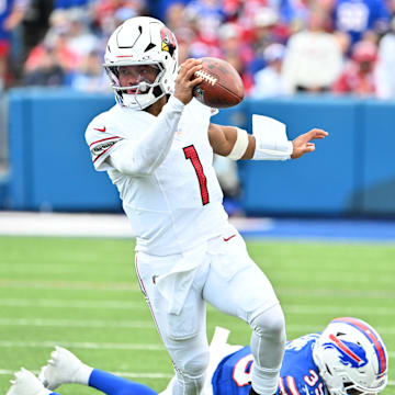 Sep 8, 2024; Orchard Park, New York, USA; Arizona Cardinals quarterback Kyler Murray (1) avoids Buffalo Bills cornerback Cam Lewis (39) to get a first down in the second quarter at Highmark Stadium. Mandatory Credit: Mark Konezny-Imagn Images