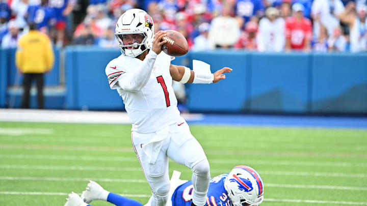 Sep 8, 2024; Orchard Park, New York, USA; Arizona Cardinals quarterback Kyler Murray (1) avoids Buffalo Bills cornerback Cam Lewis (39) to get a first down in the second quarter at Highmark Stadium. Mandatory Credit: Mark Konezny-Imagn Images