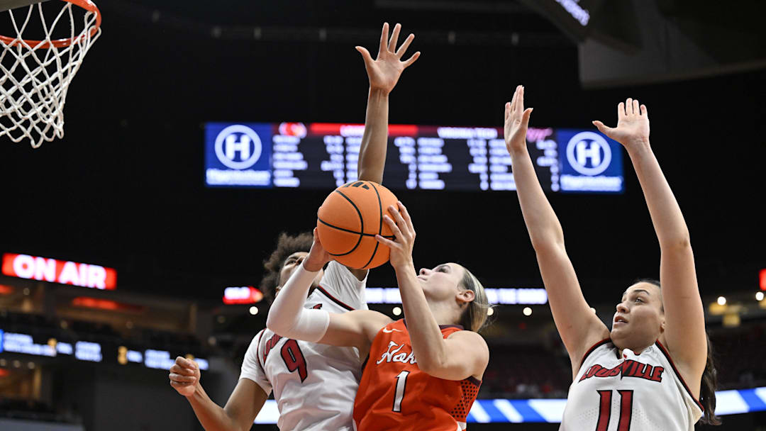 Jan 4, 2026; Louisville, Kentucky, USA;  Virginia Tech Hokies guard Carleigh Wenzel (1) shoots against Louisville Cardinals forward Anaya Hardy (9) and forward Elif Istanbulluoglu (11) during the second half at KFC Yum! Center. Louisville defeated Virginia Tech 85-60. Mandatory Credit: Jamie Rhodes-Imagn Images