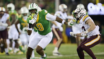 Nov 14, 2025; Eugene, Oregon, USA; Oregon Ducks tight end Jamari Johnson (9) catches a pass for a first down during the first half against Minnesota Golden Gophers defensive back John Nestor (17) at Autzen Stadium. Mandatory Credit: Troy Wayrynen-Imagn Images