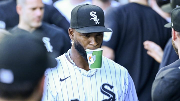 White Sox outfielder Luis Robert Jr. bites a Gatorade cup.