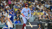 Oct 8, 2025; Los Angeles, California, USA; Philadelphia Phillies designated hitter Kyle Schwarber (12) hits a solo home run during the fourth inning against the Los Angeles Dodgers during game three of the NLDS round for the 2025 MLB playoffs at Dodger Stadium. Mandatory Credit: Jayne Kamin-Oncea-Imagn Images