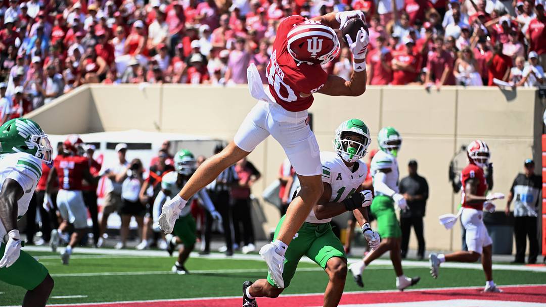 Sep 5, 2026; Bloomington, Indiana, USA; Indiana Hoosiers wide receiver Charlie Becker (80) makes a touchdown catch in front of North Texas Mean Green safety Bryce Garza (14) during the second quarter at Merchants Bank Field at Memorial Stadium. Sep 5, 2026; Bloomington, Indiana, USA; Indiana Hoosiers wide receiver Charlie Becker (80) makes a touchdown catch in front of North Texas Mean Green safety Bryce Garza (14) during the second quarter at Merchants Bank Field at Memorial Stadium.