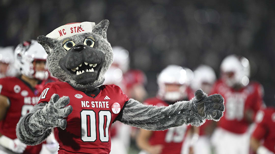 Dec 28, 2024; Annapolis, MD, USA;  North Carolina State Wolfpack mascot Mr. Wolf runs ion the field with the team before the start of the Go Bowling Military Bowl against the East Carolina Pirates  at Navy-Marine Corps Memorial Stadium. Mandatory Credit: Tommy Gilligan-Imagn Images