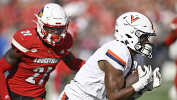 Oct 4, 2025; Louisville, Kentucky, USA; Virginia Cavaliers wide receiver Cam Ross (6) catches a pass against Louisville Cardinals defensive back D'Angelo Hutchinson (21) during the second quarter at L&N Federal Credit Union Stadium. Mandatory Credit: Jamie Rhodes-Imagn Images