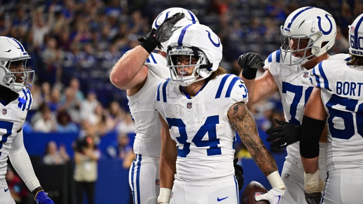 Aug 17, 2024; Indianapolis, Indiana, USA; Indianapolis Colts running back Zavier Scott (34) celebrates a touchdown during the second half against the Arizona Cardinals at Lucas Oil Stadium. 