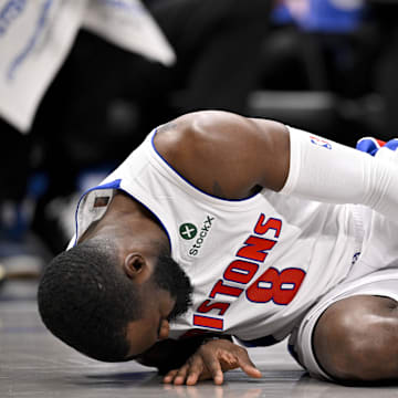 Mar 21, 2025; Dallas, Texas, USA; Detroit Pistons forward Tim Hardaway Jr. (8) grabs his leg after he falls to the floor during the first half against the Dallas Maverick at the American Airlines Center. Mandatory Credit: Jerome Miron-Imagn Images