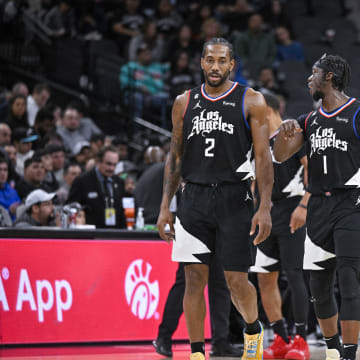 Jan 20, 2023; San Antonio, Texas, USA; LA Clippers forward Kawhi Leonard (2) and guard Reggie Jackson (1) and guard Paul George (13) walk back onto the court during the second half against the San Antonio Spurs at the AT&T Center. Mandatory Credit: Jerome Miron-USA TODAY Sports