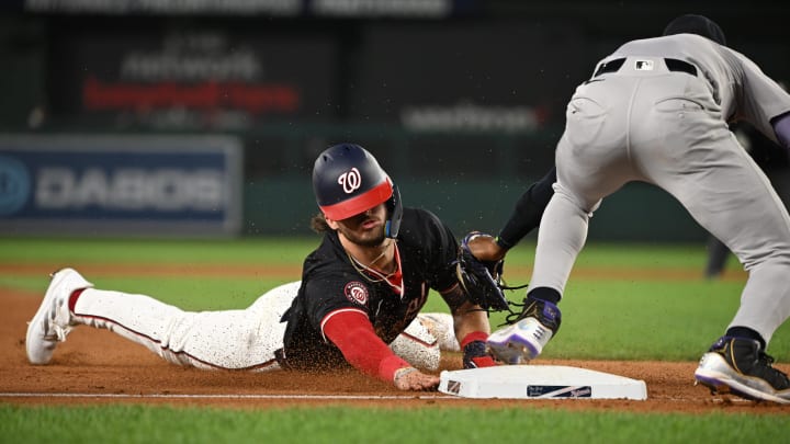 Aug 27, 2024; Washington, District of Columbia, USA; Washington Nationals center fielder Dylan Crews (3) dives into third base in front of New York Yankees third baseman Jazz Chisholm Jr. (13) during the sixth inning at Nationals Park. 