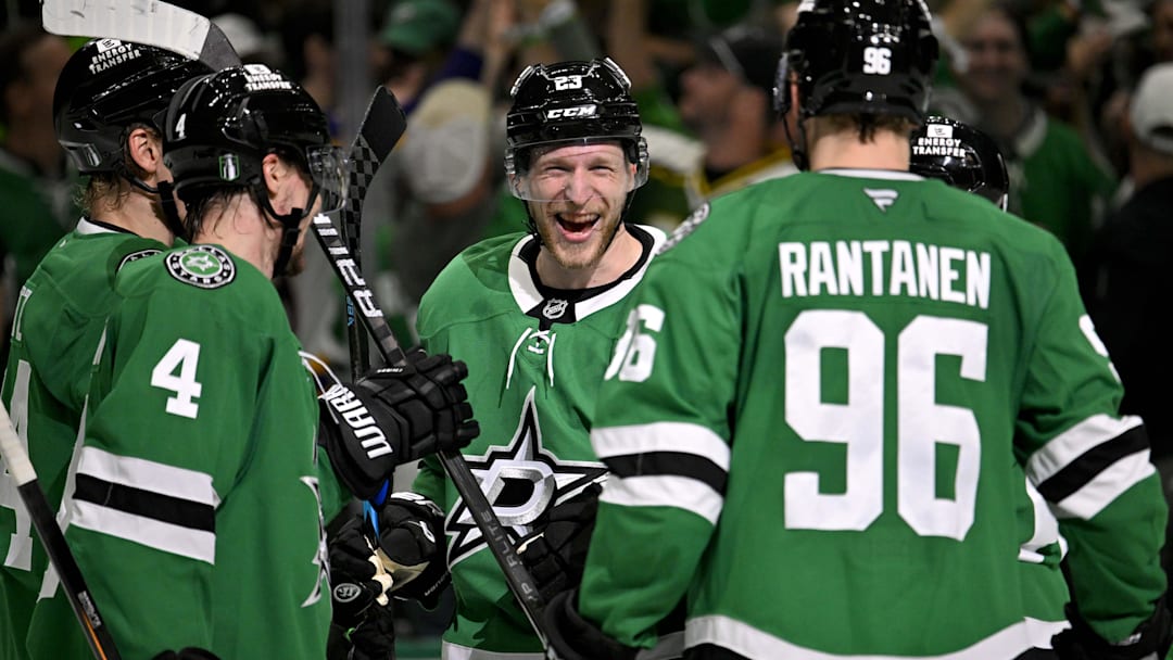 May 21, 2025; Dallas, Texas, USA; Dallas Stars defenseman Miro Heiskanen (4) and defenseman Esa Lindell (23) and right wing Mikko Rantanen (96) celebrate the empty net goal scored by Lindell against the Edmonton Oilers during the third period in game one of the Western Conference Final of the 2025 Stanley Cup Playoffs at American Airlines Center. Mandatory Credit: Jerome Miron-Imagn Images